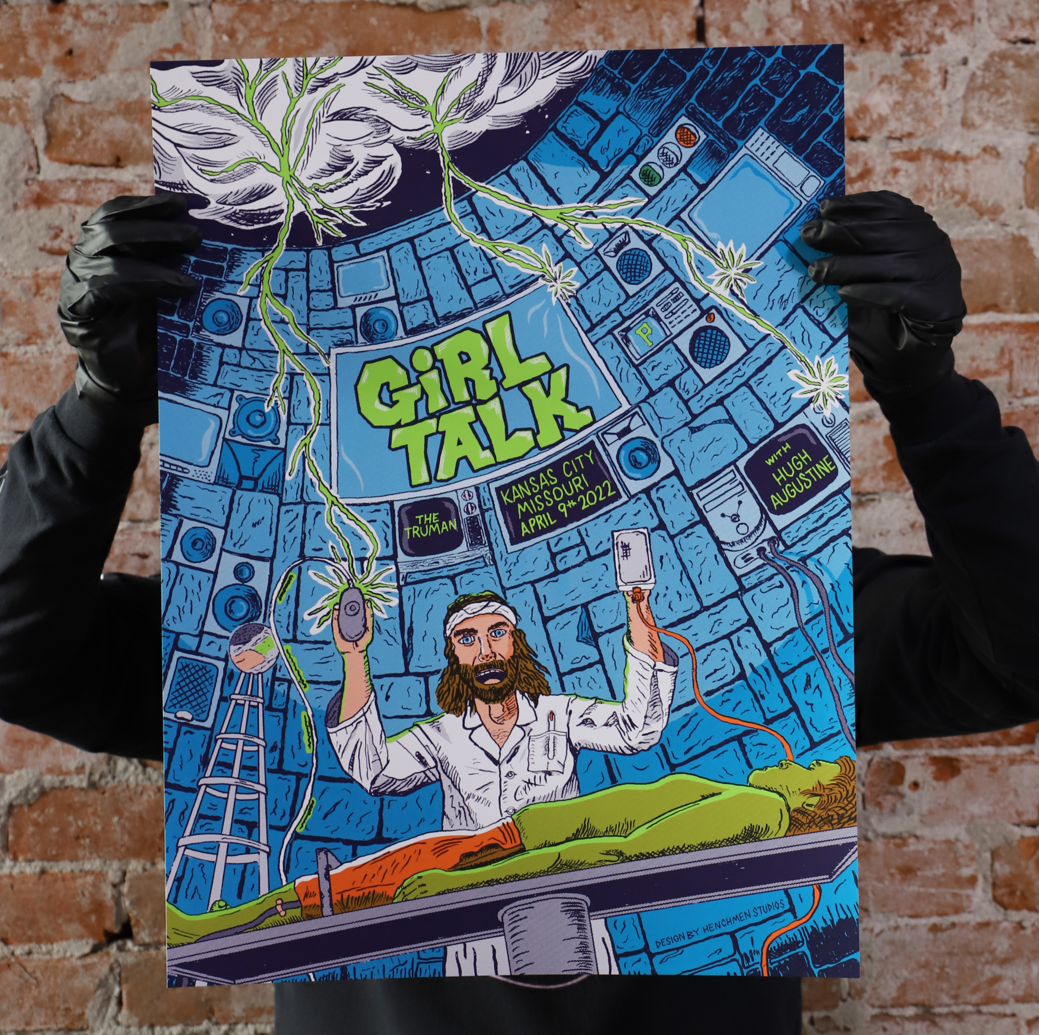 Girl Talk poster being held up, picture of a mad scientist in his lair