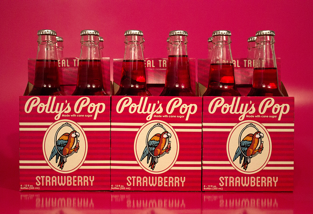 Cherry Polly's Pop soda on a red background